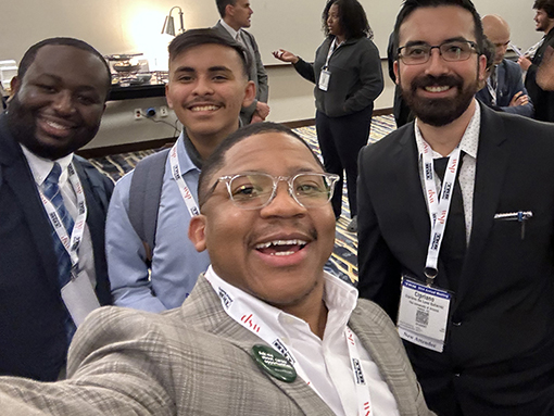 Group of colleagues taking a selfie at a conference reception