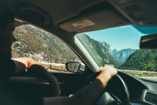 man driving through mountainous region